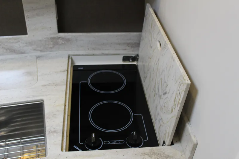 Slide: The Image of 2016 Formula 37 PC kitchen with sleek electric stovetop and marble countertop. - 40