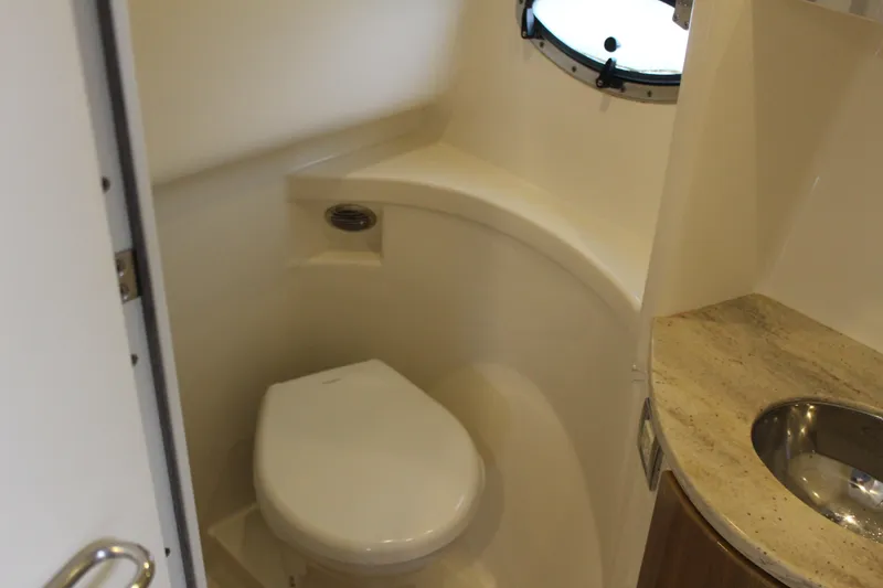 Slide: The Image of 2016 Formula 37 PC yacht bathroom with toilet, sink, and porthole window. - 42