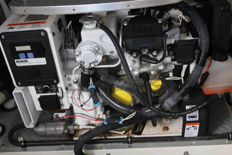 Slide: The Image of Engine compartment of a 2016 Formula 37 PC boat, featuring a Kohler generator. - 48