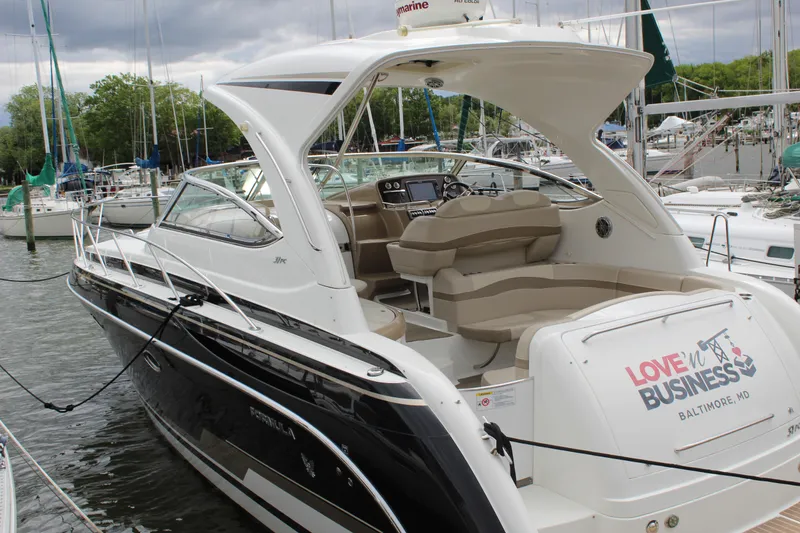 Slide: The Image of 2016 Formula 37 PC yacht docked, featuring sleek design and spacious seating. - 5