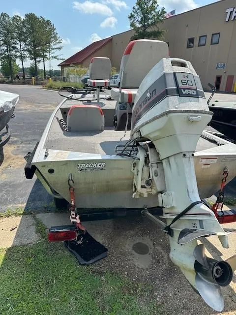 Slide: The Image of 2010 Bass Tracker Pro 16 boat with outboard motor, parked outdoors. - 4