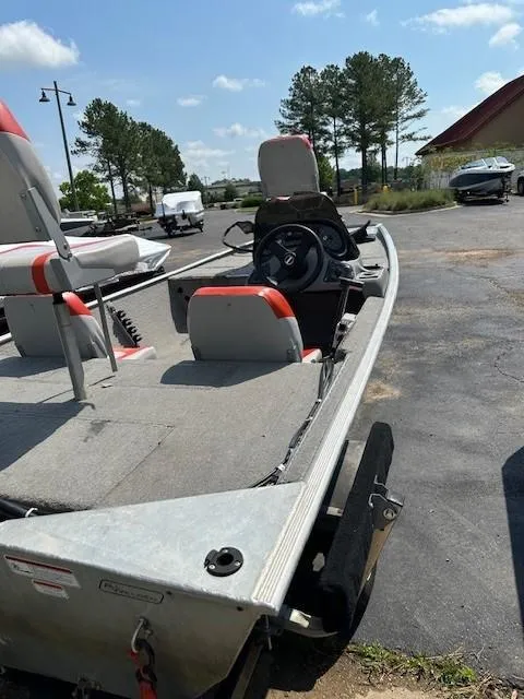Slide: The Image of 2010 Bass Tracker Pro 16 boat with seating, steering wheel, and outdoor setting. - 5