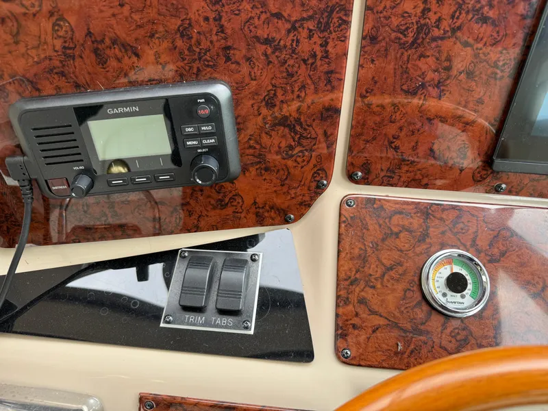 Slide: The Image of Control panel of a 2001 Sea Ray 340 Amberjack with Garmin device and trim tabs. - 10