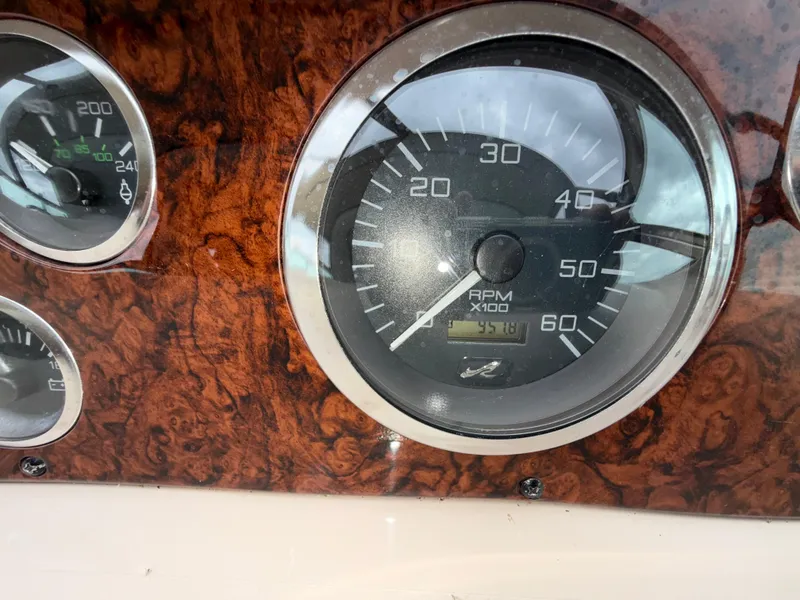 Slide: The Image of Close-up of 2001 Sea Ray 340 Amberjack dashboard gauges, showing RPM and temperature. - 11