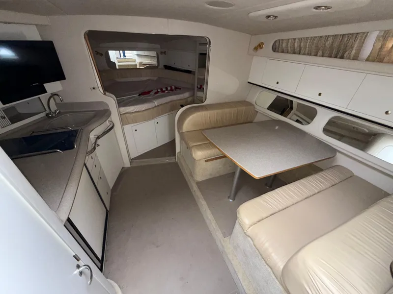Slide: The Image of 2001 Sea Ray 340 Amberjack interior with kitchenette, dining area, and sleeping quarters. - 12