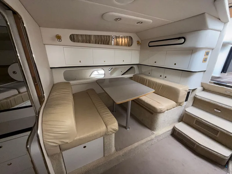 Slide: The Image of Interior of 2001 Sea Ray 340 Amberjack yacht with beige seating and dining area. - 14