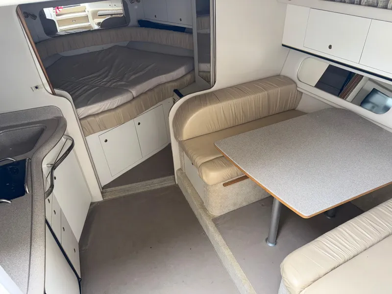 Slide: The Image of 2001 Sea Ray 340 Amberjack cabin interior with dining area and sleeping quarters. - 15
