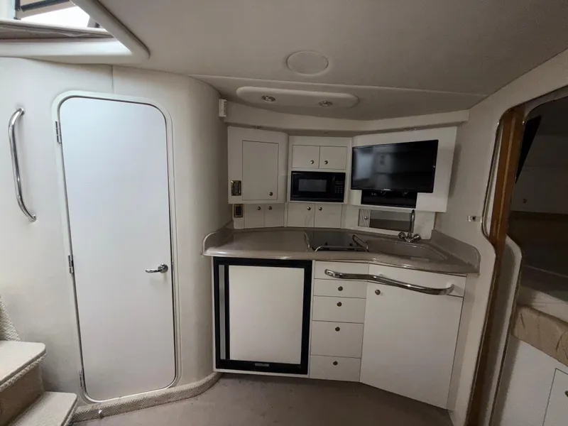 Slide: The Image of Interior of 2001 Sea Ray 340 Amberjack boat with kitchenette and modern amenities. - 16