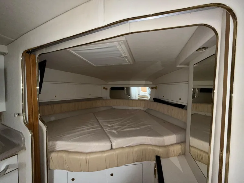 Slide: The Image of Interior cabin of 2001 Sea Ray 340 Amberjack with cozy bed and storage cabinets. - 19