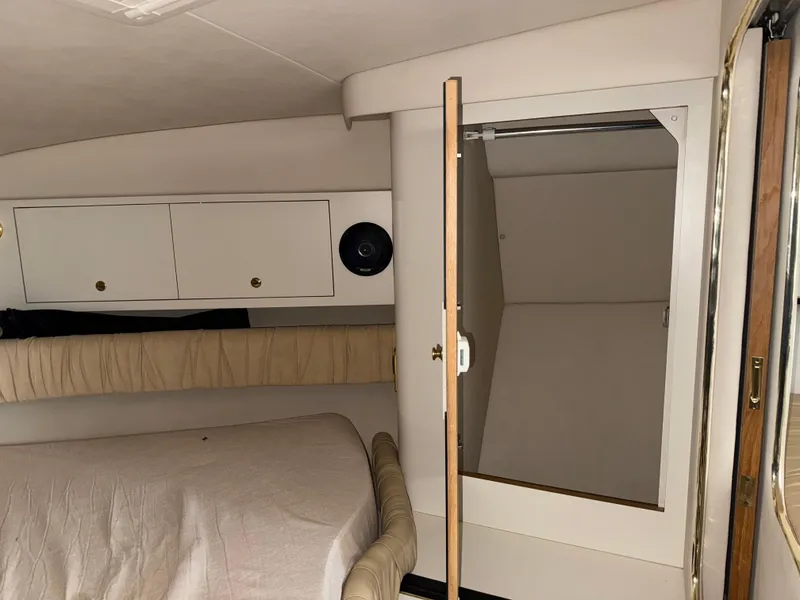 Slide: The Image of Interior cabin of 2001 Sea Ray 340 Amberjack with open closet and storage cabinets. - 21