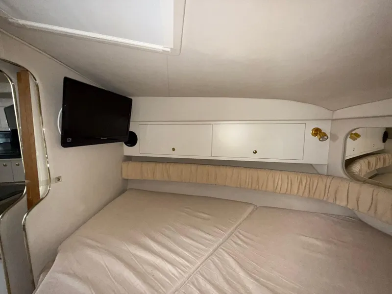 Slide: The Image of Interior cabin of 2001 Sea Ray 340 Amberjack with bed, TV, and storage cabinets. - 22