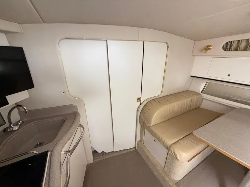 Slide: The Image of 2001 Sea Ray 340 Amberjack interior with kitchenette, seating, and storage. - 24