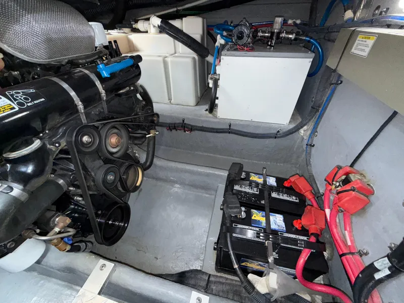Slide: The Image of Engine compartment of a 2001 Sea Ray 340 Amberjack with visible batteries and components. - 31