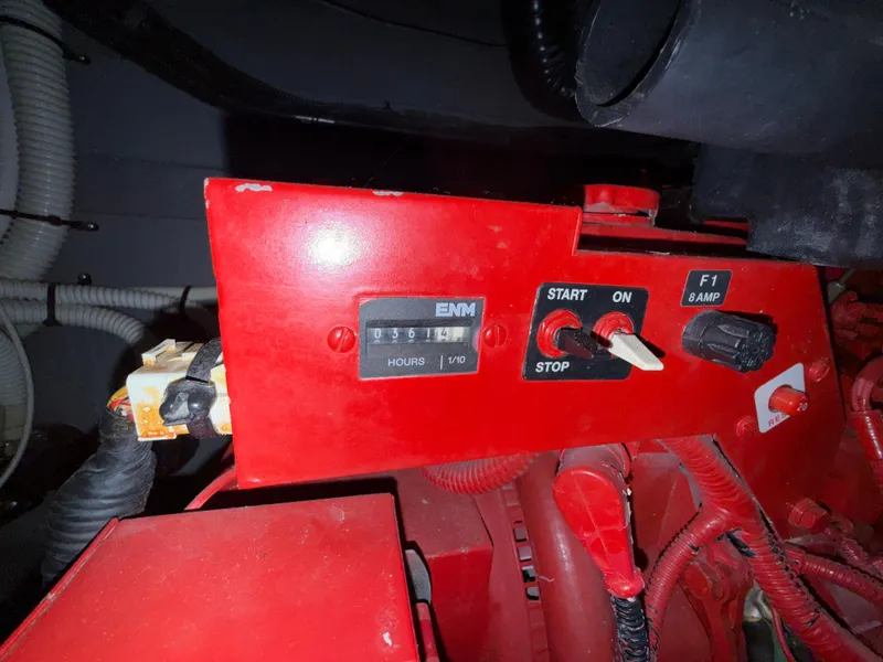 Slide: The Image of Control panel of a 2001 Sea Ray 340 Amberjack boat engine, featuring switches and hour meter. - 33