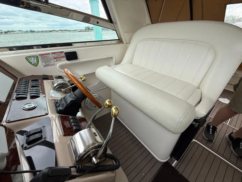 Slide: The Image of Interior helm of 2001 Sea Ray 340 Amberjack with white seating and control panel. - 4