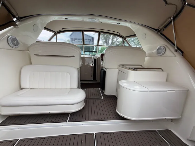 Slide: The Image of Interior of 2001 Sea Ray 340 Amberjack boat with white seating and wood flooring. - 6