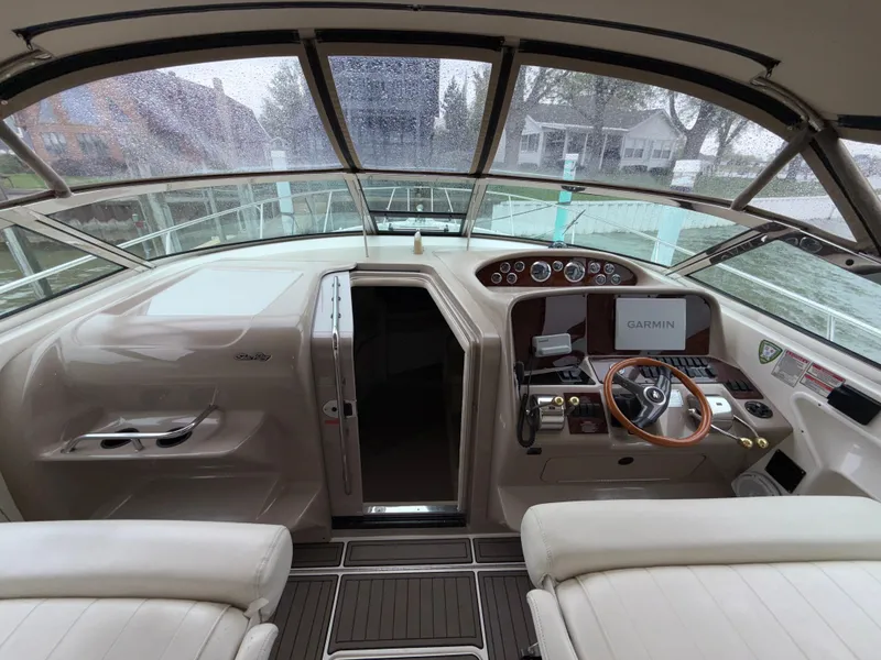 Slide: The Image of 2001 Sea Ray 340 Amberjack helm with Garmin navigation, featuring a sleek design and comfortable seating. - 7