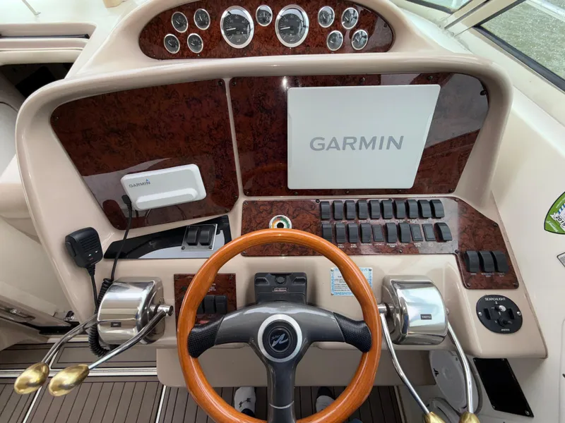 Slide: The Image of Helm of 2001 Sea Ray 340 Amberjack with Garmin navigation system and wooden steering wheel. - 8