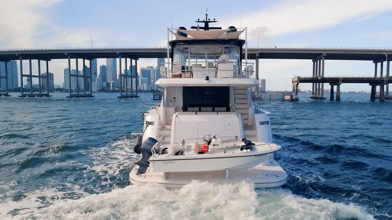 Slide: The Image of 2017 Hatteras M75 Panacera yacht cruising under a city bridge. - 14