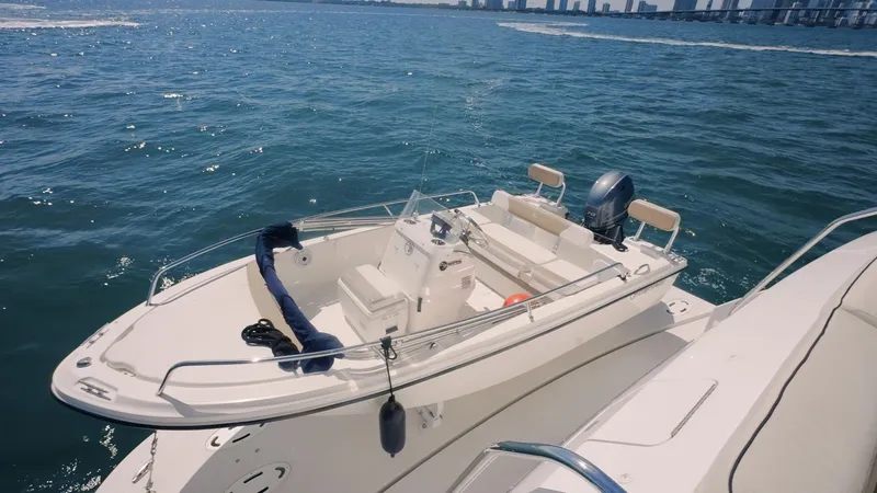 Slide: The Image of 2017 Hatteras M75 Panacera yacht on open water with city skyline in background. - 17