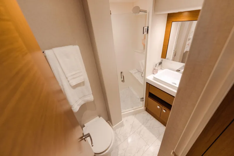 Slide: The Image of Luxurious bathroom in 2017 Hatteras M75 Panacera yacht with marble flooring and modern fixtures. - 20