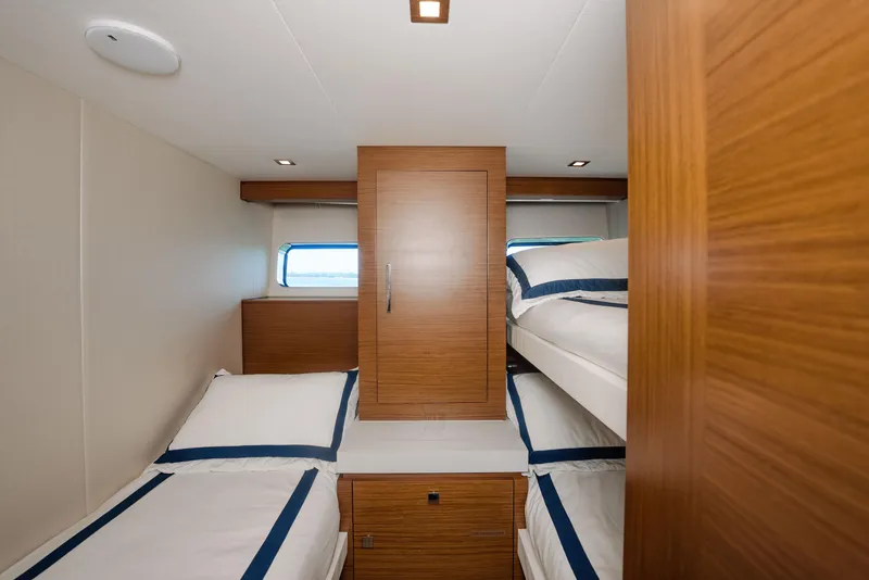 Slide: The Image of 2017 Hatteras M75 Panacera cabin with twin beds and wooden cabinetry. - 27