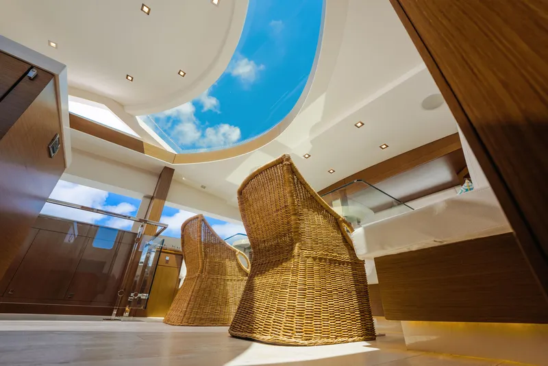 Slide: The Image of Luxurious interior of 2017 Hatteras M75 Panacera yacht with wicker chairs and skylight. - 40