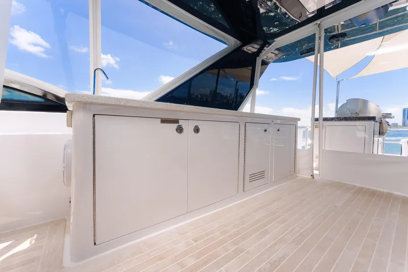 Slide: The Image of Luxurious 2017 Hatteras M75 Panacera yacht deck with sleek cabinetry and ocean view. - 49