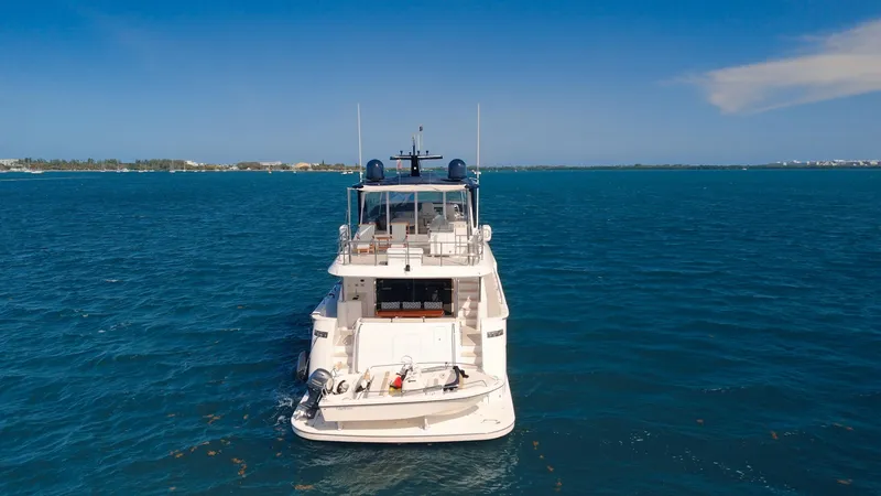 Slide: The Image of 2017 Hatteras M75 Panacera yacht on open blue sea, rear view. - 5
