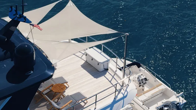 Slide: The Image of Luxurious 2017 Hatteras M75 Panacera yacht deck with sunshade, overlooking blue ocean waters. - 9