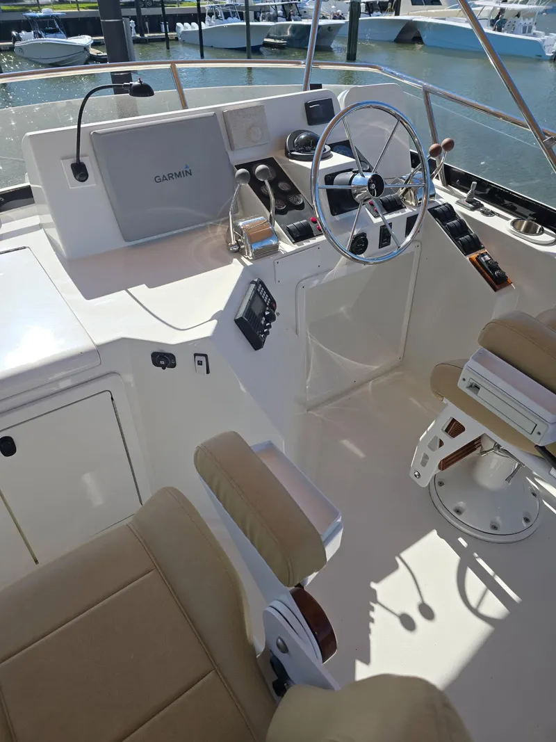 Slide: The Image of 2004 Sabre 36 Flybridge Fast Trawler helm with steering wheel and navigation equipment. - 42