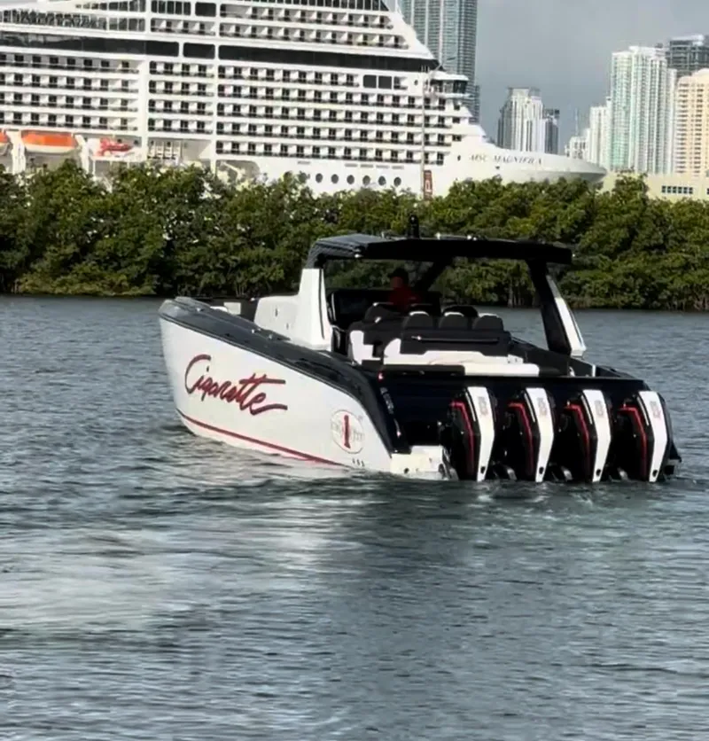 The Image of 2024 Cigarette 42 Auroris boat with four engines cruising near a cruise ship. - 0