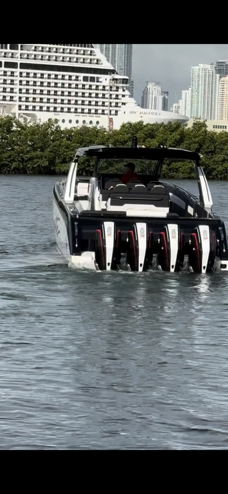 Slide: The Image of 2024 Cigarette 42 Auroris boat with multiple engines cruising on water, cityscape in background. - 1