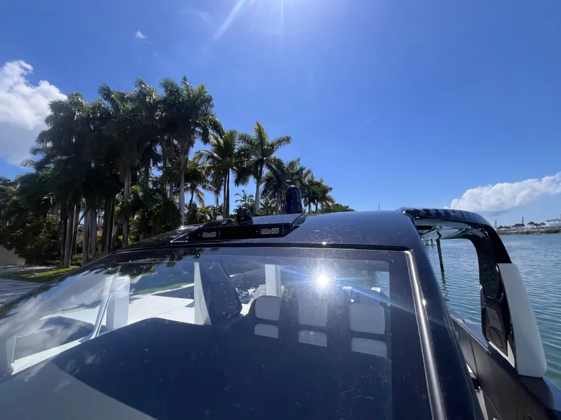 Slide: The Image of 2024 Cigarette 42 Auroris boat with palm trees and blue sky background. - 16