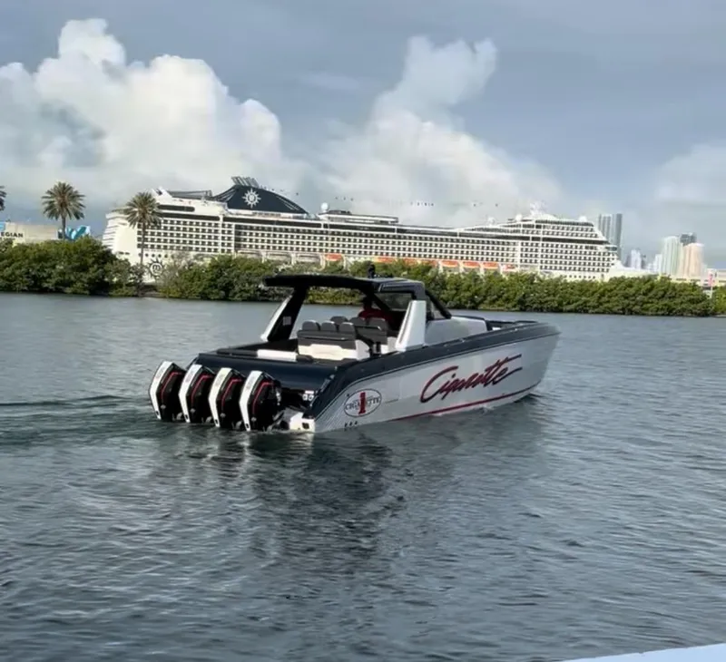 Slide: The Image of 2024 Cigarette 42 Auroris boat cruising near a large cruise ship. - 2