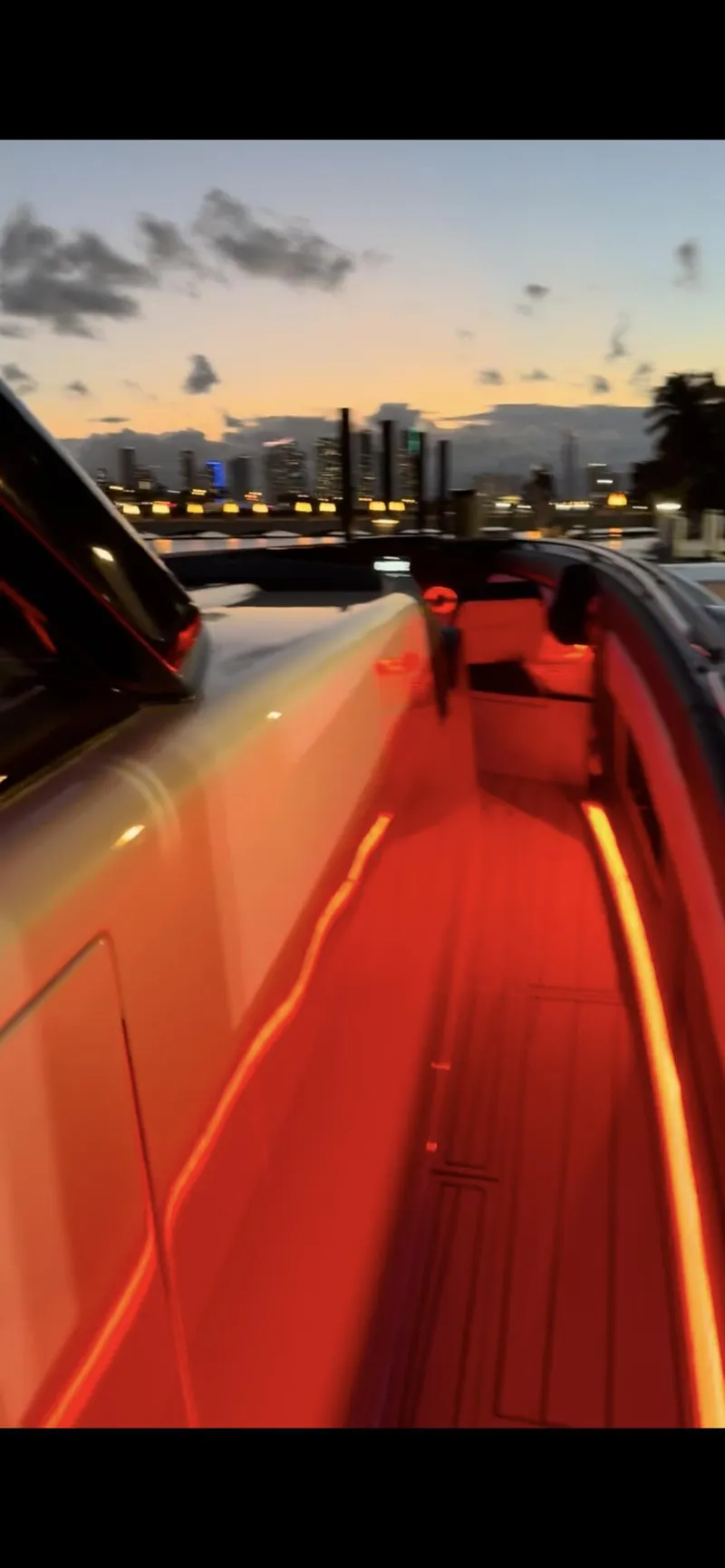 Slide: The Image of 2024 Cigarette 42 Auroris yacht with vibrant red deck lighting at sunset. - 29