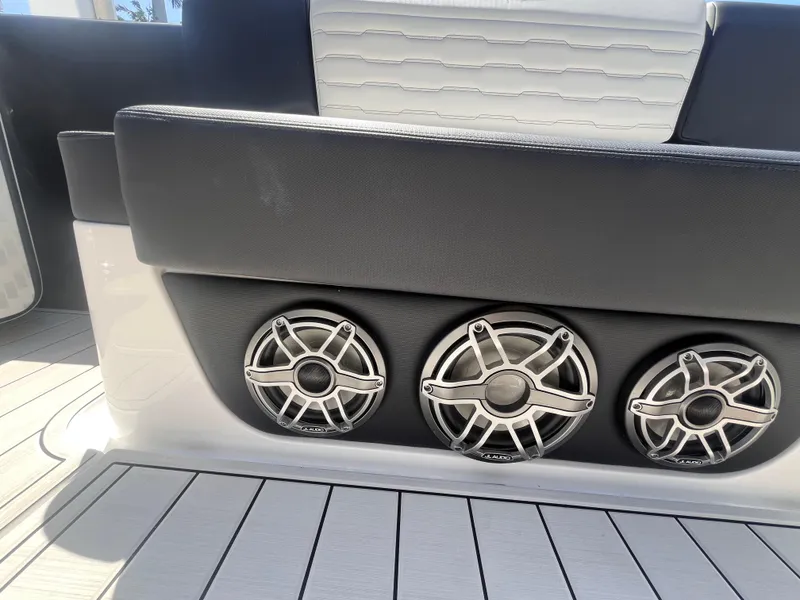 Slide: The Image of 2024 Cigarette 42 Auroris boat interior with sleek black seating and three stylish speakers. - 36