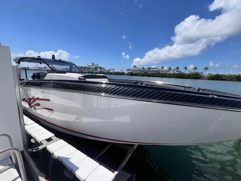 Slide: The Image of 2024 Cigarette 42 Auroris boat docked under a clear blue sky. - 43