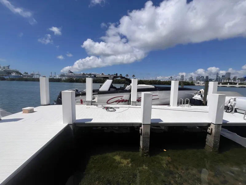 Slide: The Image of 2024 Cigarette 42 Auroris boat docked at a marina under a clear blue sky. - 44