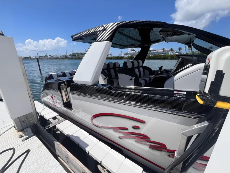 Slide: The Image of 2024 Cigarette 42 Auroris boat docked, showcasing sleek design and luxurious seating. - 7