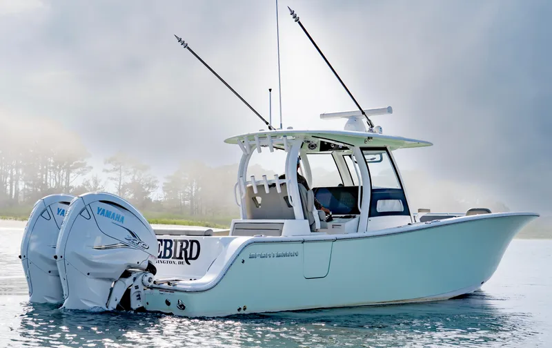 Slide: The Image of 2021 Sportsman Open 322 Center Console boat on water with dual Yamaha engines. - 1