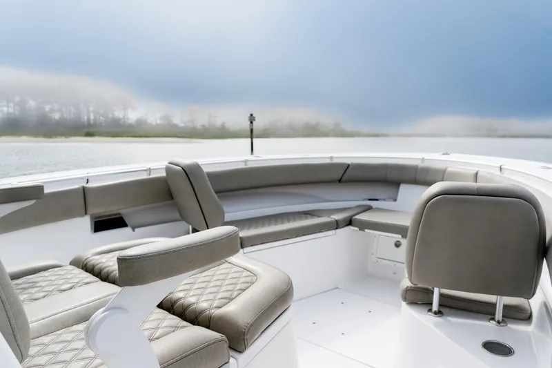 Slide: The Image of 2021 Sportsman Open 322 Center Console boat interior with cushioned seating. - 10