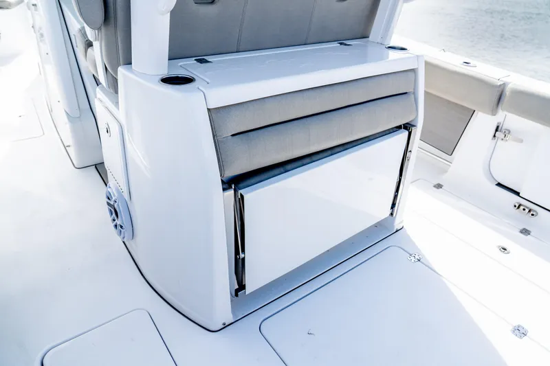 Slide: The Image of 2021 Sportsman Open 322 Center Console boat interior with seating and storage. - 11