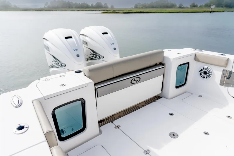 Slide: The Image of 2021 Sportsman Open 322 Center Console boat with twin Yamaha engines on calm water. - 12