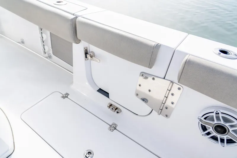 Slide: The Image of 2021 Sportsman Open 322 Center Console boat interior with cushioned seating and speaker. - 17