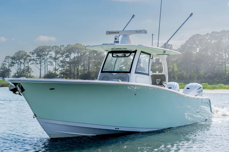 Slide: The Image of 2021 Sportsman Open 322 Center Console boat cruising on a sunny day. - 2