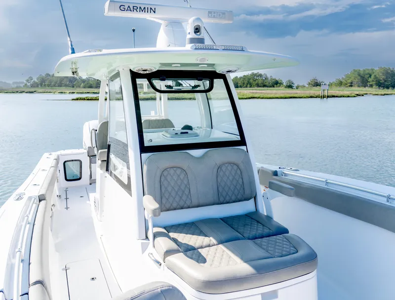 Slide: The Image of 2021 Sportsman Open 322 Center Console boat on calm water, featuring Garmin equipment. - 7