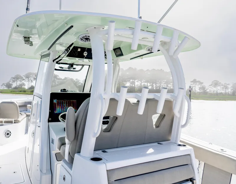 Slide: The Image of 2021 Sportsman Open 322 Center Console boat interior with rod holders and seating. - 8