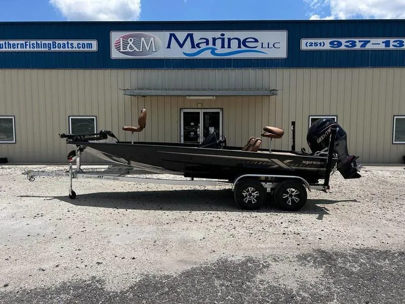 Slide: The Image of 2025 Xpress H20C Crappie boat on trailer outside L&M Marine LLC building. - 0
