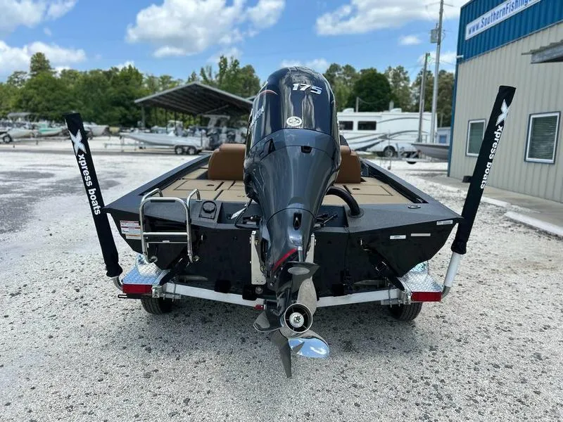 Slide: The Image of 2025 Xpress H20C Crappie boat with powerful outboard motor, parked outdoors. - 10